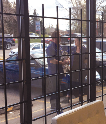 Commercial window bar panel shown fixed to storefront Edmonton